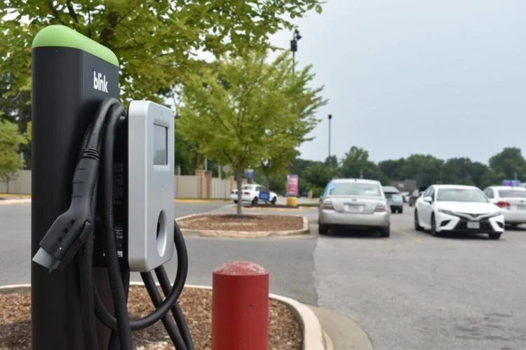 An electric vehicle charger in a small-town parking lot