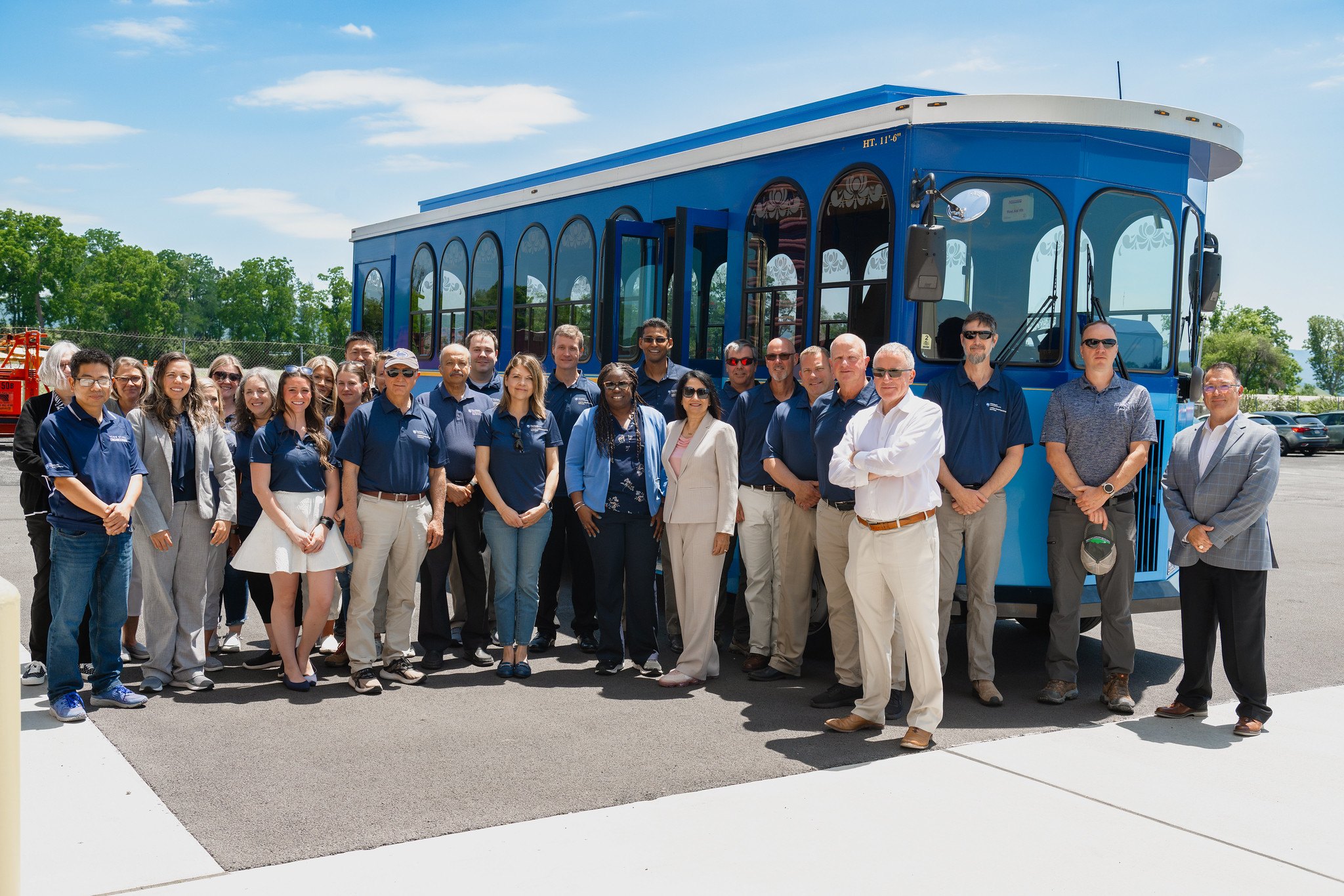 Lab members and Larson Transportation Institute staff in front of the Penn State trolley at the test track