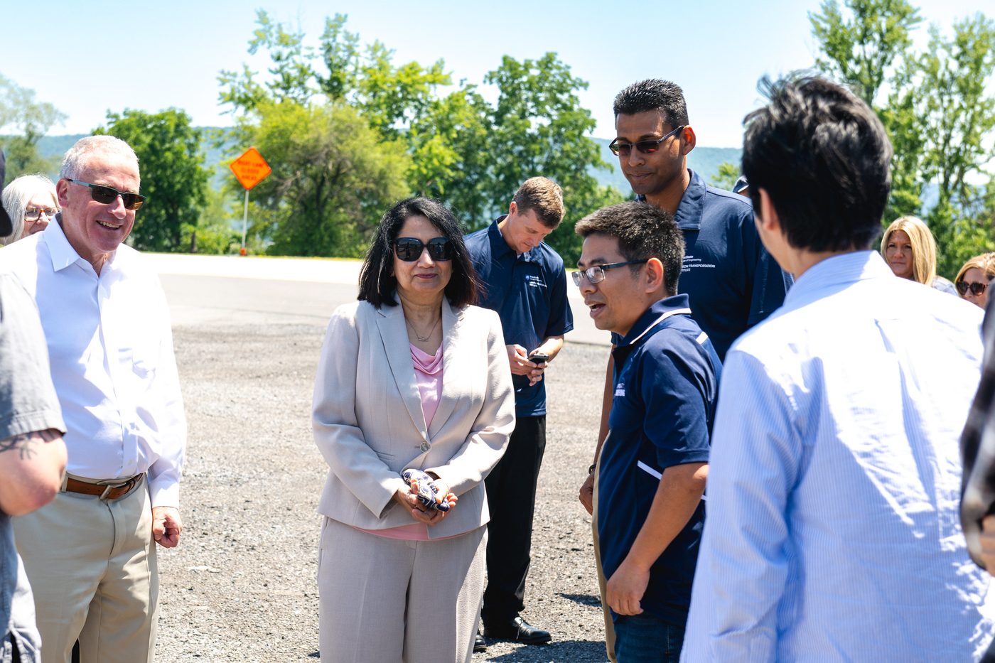 President Bendapudi talking with students on the test track