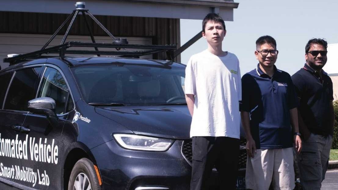 Lab members beside the automated vehicle