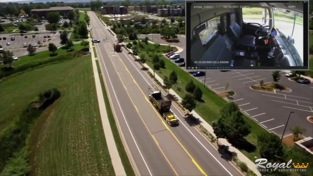Aerial view of a lead truck and a driverless follow truck on a suburban road