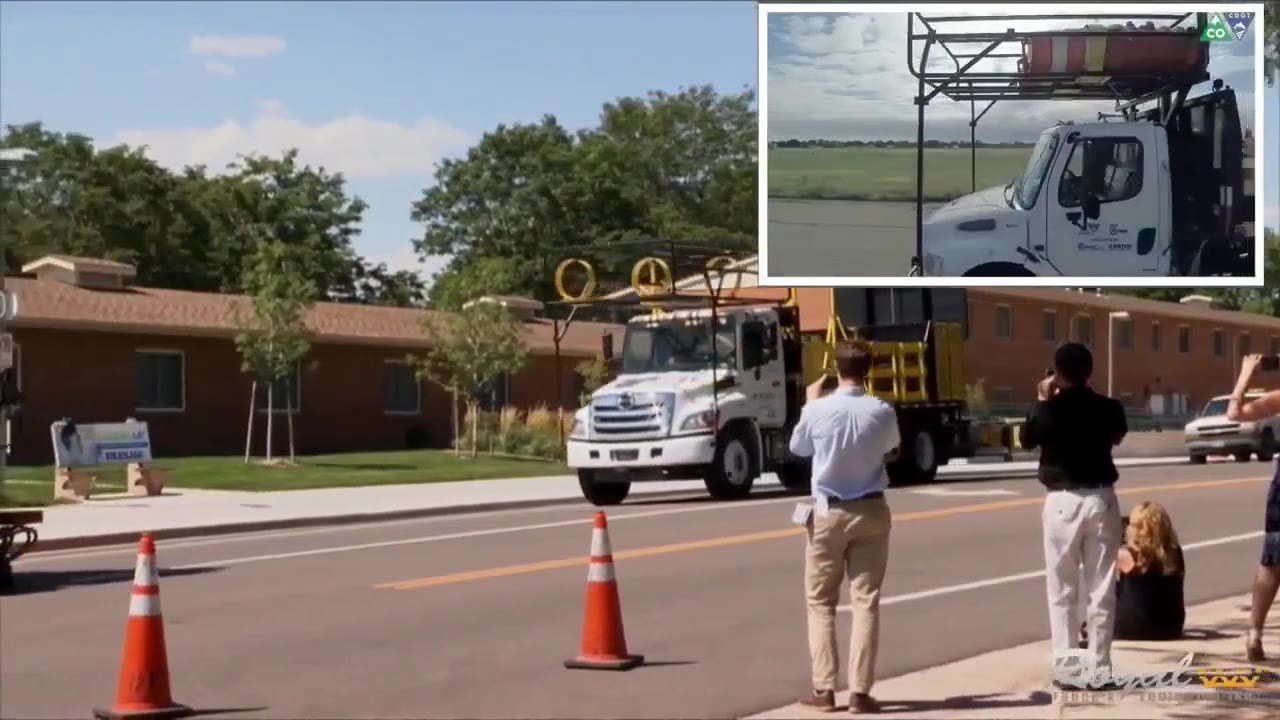 A driverless truck mounted attenuator truck at a live demonstration, with state DOT observers beside the roadway