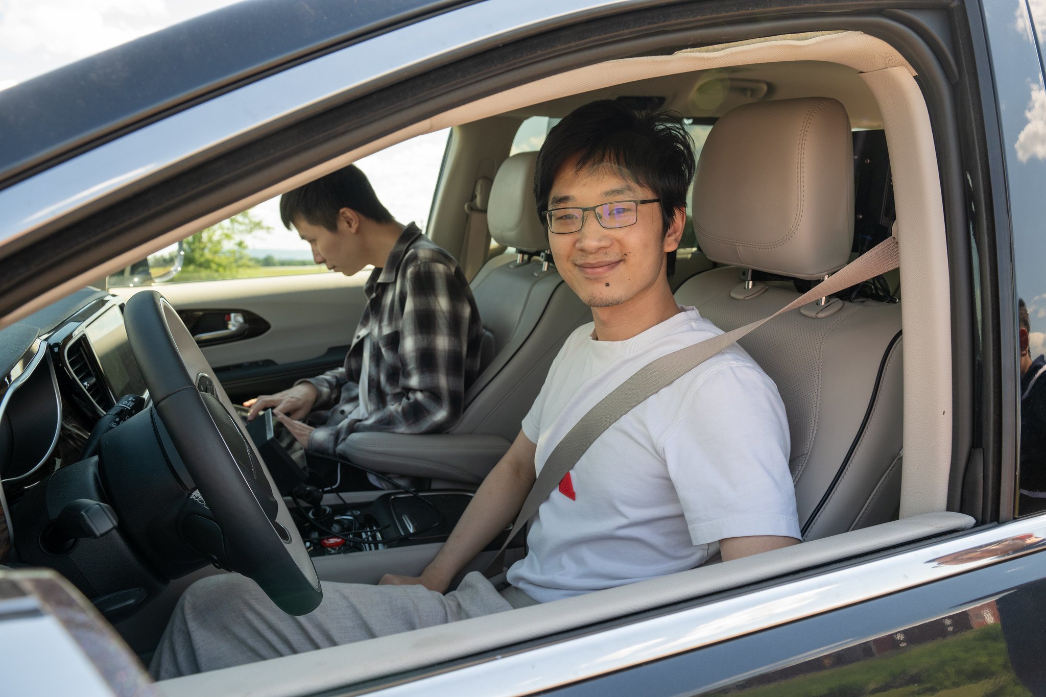 Lab members in the driver and passenger seats